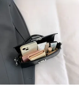 Internal view of black crossbody bag showing spacious storage for essentials
