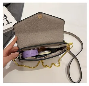 Detail view of the oatmeal crossbody bag interior showing storage space for cosmetics