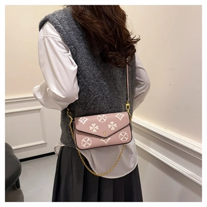 Detailed back view of pink patterned crossbody bag with gold chain and leather strap
