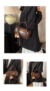 Women vintage brown boston bag stylish pillow handbag commute crossbody bag with cute charm.