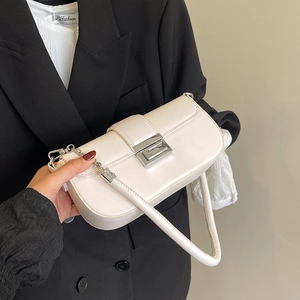Detail of ivory faux leather shoulder bag with silver rectangle twist lock and chain