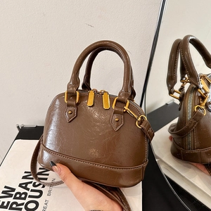 Retro shell handbag in dark brown cracked leather texture with gold hardware