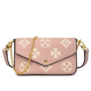 Pink lychee grain leather crossbody bag with clover print and gold chain strap