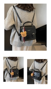 Detail of black textured PU leather bag with bear charm and Fashion & Bags text