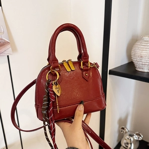 Classic burgundy shell handbag made of oil-wax faux leather with gold heart charm