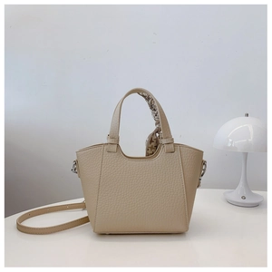 Chic beige lychee leather handbag detail with decorative geometric print silk scarf handle