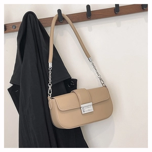 Detail of beige shoulder bag with silver rectangle clasp and leather-chain strap