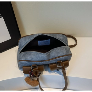 Top view of washed denim tote bag with brown leather trim and spacious interior