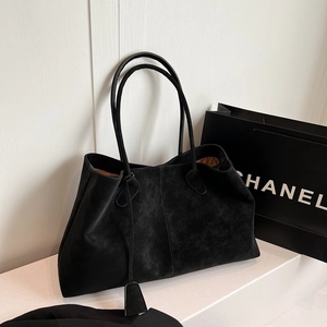 Large black tote bag in matte suede texture with slim handles and brown lining interior