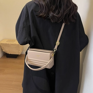 Minimalist cream beige rectangular box bag with gold-tone hardware and crossbody strap