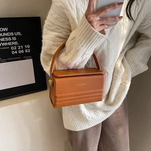 Elegant box-shaped caramel handbag with top handle and gold metal hardware for women