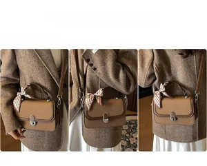 Brown woven crossbody bag with silk scarf detail shown on model in street style