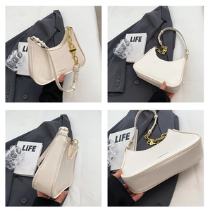 Detail view of cream crescent shoulder bag with golden chain and smooth PU leather texture