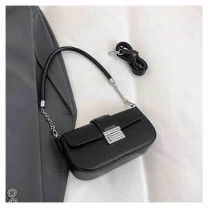 Detail of black leather small square bag with silver hardware and chain strap