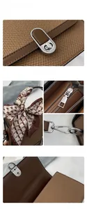 Detail of silver twist lock and silk scarf handle on brown textured crossbody bag