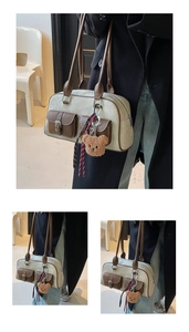 Detail view of vintage Boston bag featuring double front pockets and brown leather trim