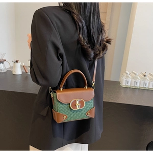 Detail showing contrast weave and leather crossbody bag worn by a model in interior