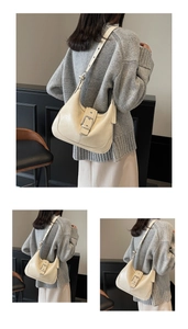Detail of cream hobo shoulder bag with silver buckle and adjustable strap