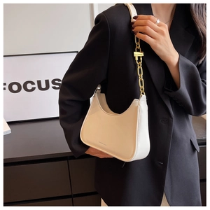 Detail of hobo shoulder bag in beige leather featuring a chunky gold chain strap