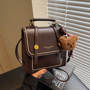 Retro dark brown PU leather handbag with gold buckle and cute bear pendant charm