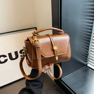 Maillard brown Boston handbag in oily PU leather with a minimalist retro square design