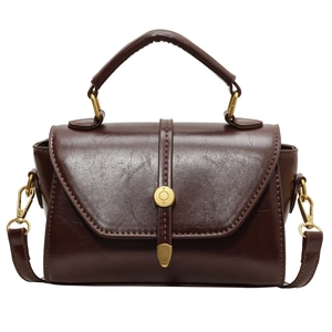 Maillard brown vintage Boston handbag with glossy leather finish and gold buckle