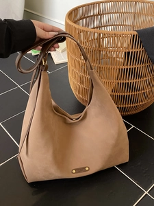 Brown matte suede hobo tote bag with spacious interior and elegant leather shoulder strap