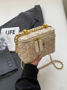 Elegant beige tweed crossbody chain bag with gold accents and floral metallic hardware