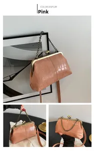 Detailed view of pink crocodile pattern kiss-lock bag with retro metal chain handle
