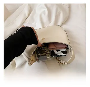 Internal view of cream baguette bag showing capacity for phone and short wallet