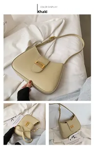 Detail view of khaki baguette bag with gold chain buckle and adjustable strap