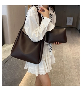 Deep coffee two-piece tote bag set shown with large shoulder bag and zipper pouch on model