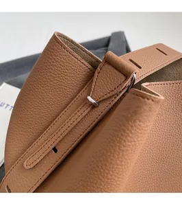 Detailed macro view of caramel lychee grain leather bucket bag with precise stitching