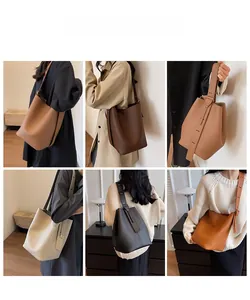 Showcase of minimalist bucket bag in multiple colors featuring lychee grain leather texture