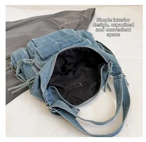 Detailed interior view of the denim tote showing zipper pocket and dual slot pockets