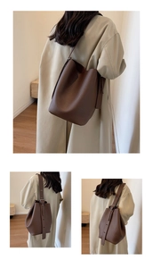 Detail of dark brown lychee textured bucket bag with adjustable shoulder strap