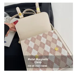 Detail showing the golden hardware magnetic buckle on the pink diamond lattice bag