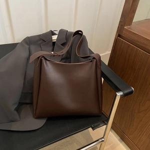 Minimalist deep brown leather tote bag with a spacious interior for office and daily use