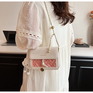 Chic cream and pink woven leather crossbody bag with chain strap and cloud charm