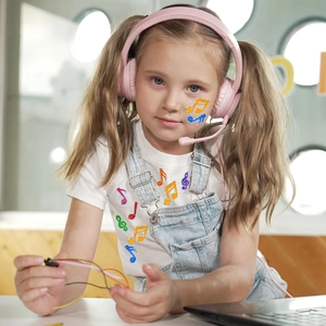 Close-up of a young girl wearing pink music note stickers on her cheeks and white T-shirt