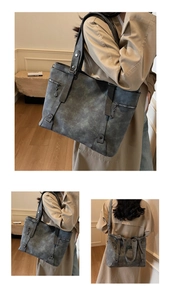 Détails d'un grand sac cabas gris foncé avec texture et rivets métalliques élégants