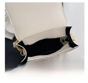 Detail view of the mini backpack interior featuring a gold zipper and side pocket
