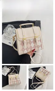 Detail of argyle pattern mini backpack in beige with gold lock and adjustable strap