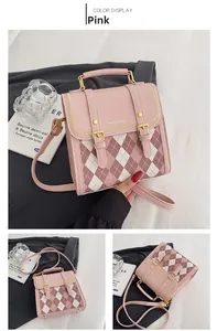 Detail of pink diamond lattice crossbody bag with dual straps and fashion logo