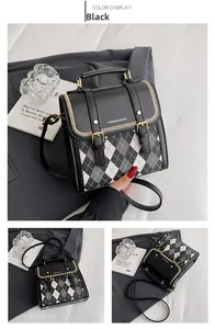 Detail of British style diamond lattice crossbody bag with black leather and metal accents