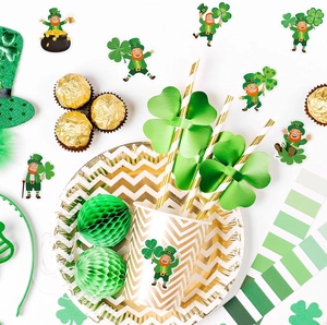 St. Patrick's Day party supplies set with gold paper plates and clover leprechaun stickers