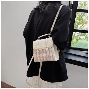 Fashionable diamond pattern mini backpack shown from back on a model wearing elegant dress