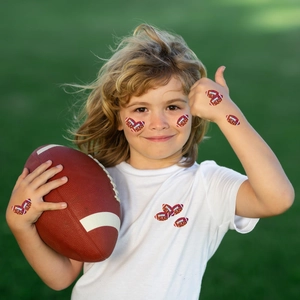 Waterproof American football glitter stickers applied on a child's skin and white T-shirt