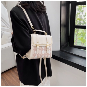 Detail shot of the quilted argyle backpack featuring metal chain accents and top handle
