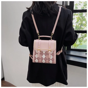 Close-up of pink diamond quilted PU leather mini backpack with gold hardware accents